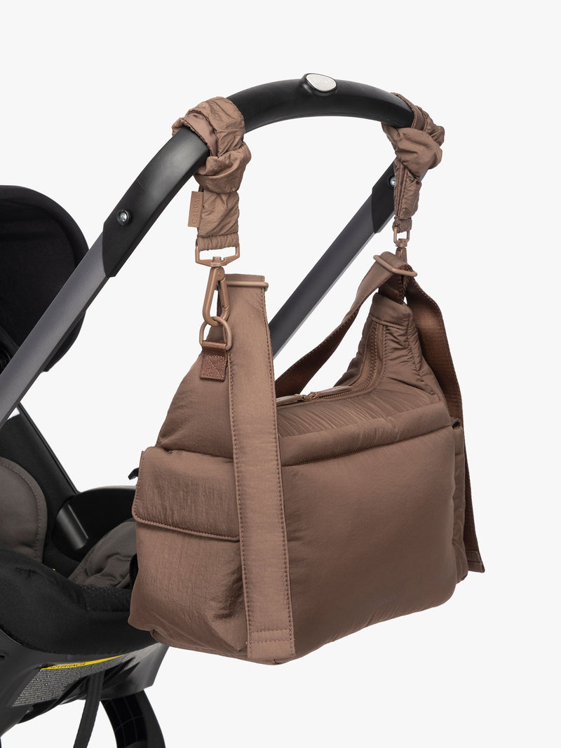 CDB2501_CROSSBODY-DIAPER-BAG_HAZELNUT_ON-STROLLER.jpg